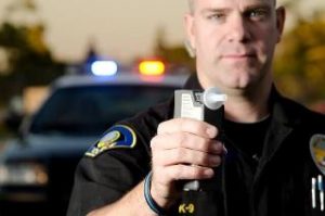 Policer officer monitoring a driver with a Breathalyzer in Vail.