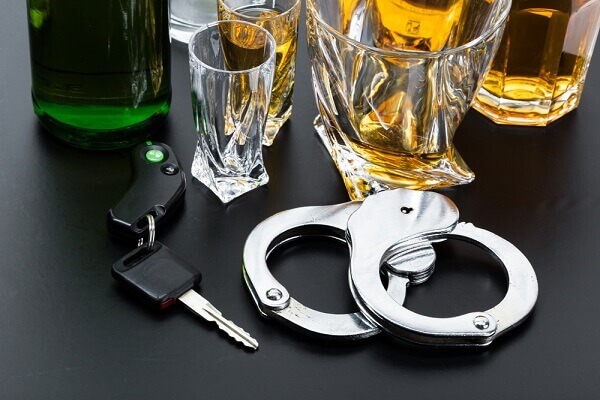 Glass for beers, car key, and a handcuff.