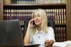 A lawyer in Glenwood Springs reviewing a personal injury case to her client through a call.