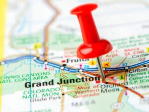 A pin pointing to Grand Junction on a map.